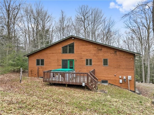 rear view of house featuring a wooden deck