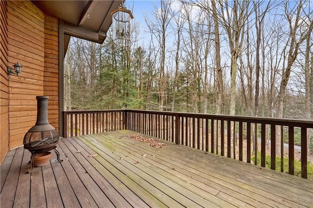 wooden deck with an outdoor fire pit