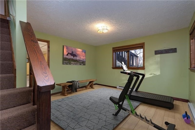 exercise area featuring a textured ceiling