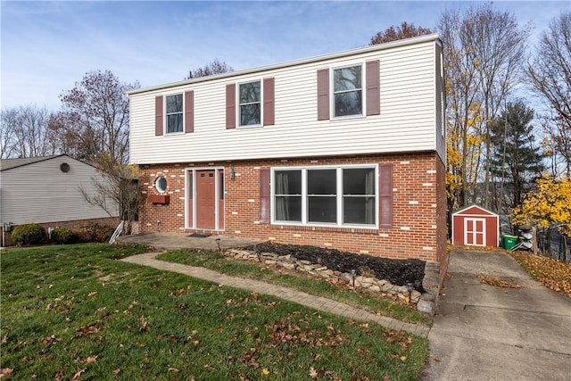 front of property featuring a front lawn and a storage unit