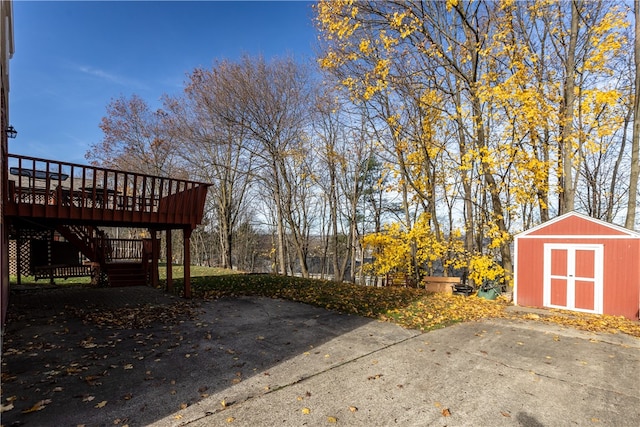 view of patio / terrace featuring a storage shed and a wooden deck