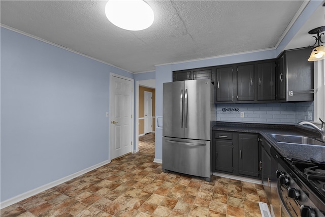 kitchen featuring sink, stainless steel appliances, tasteful backsplash, a textured ceiling, and ornamental molding