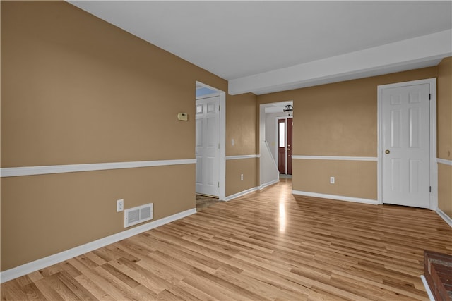 spare room featuring light hardwood / wood-style floors