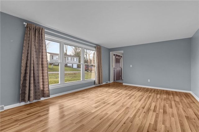 unfurnished room with light hardwood / wood-style floors