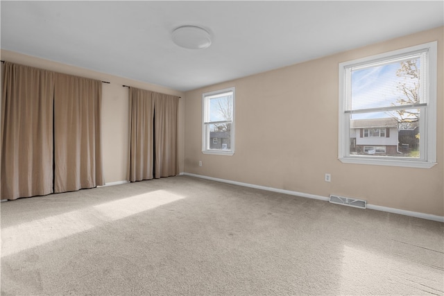 carpeted spare room with a wealth of natural light