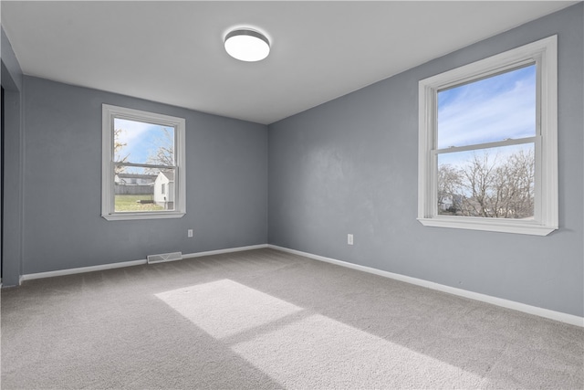 unfurnished room featuring carpet