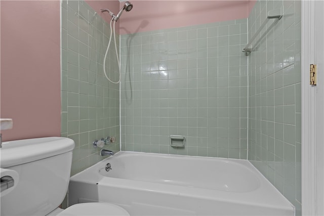 bathroom featuring tiled shower / bath and toilet