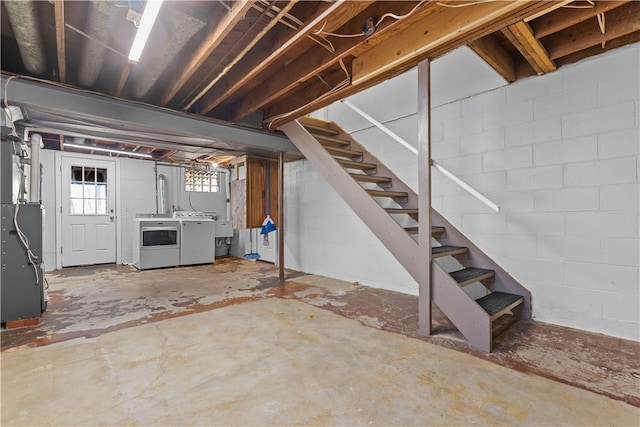 basement featuring washing machine and dryer and heating unit