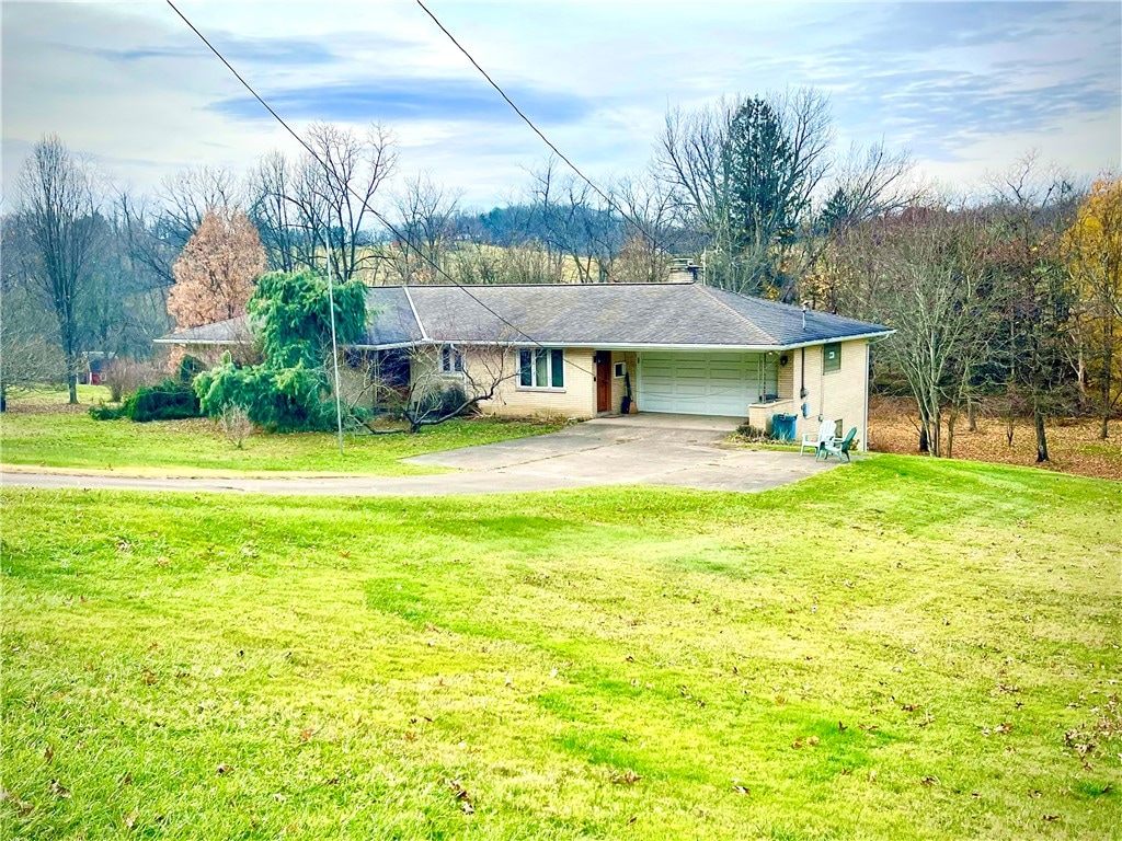 view of front of house with a garage and a front lawn