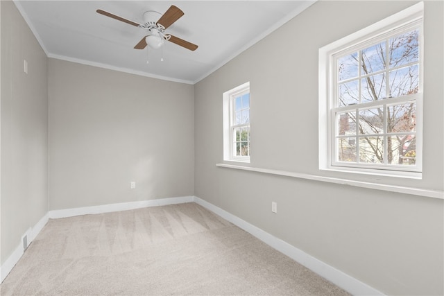 carpeted empty room with ceiling fan and ornamental molding