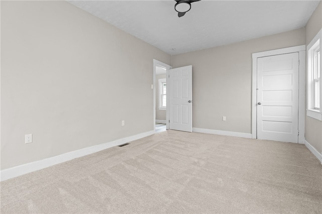 unfurnished bedroom featuring light carpet