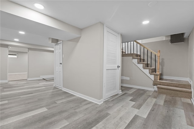 basement with light hardwood / wood-style flooring