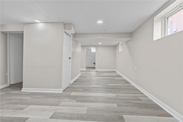 basement with light hardwood / wood-style flooring