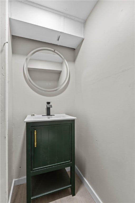 bathroom with hardwood / wood-style floors and vanity