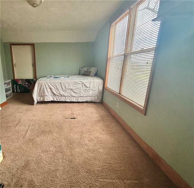 bedroom featuring carpet and a textured ceiling