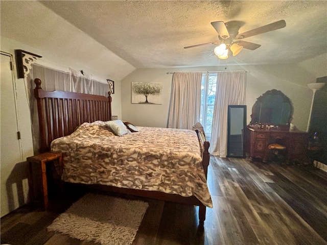 bedroom featuring a textured ceiling, ceiling fan, dark wood-type flooring, and lofted ceiling