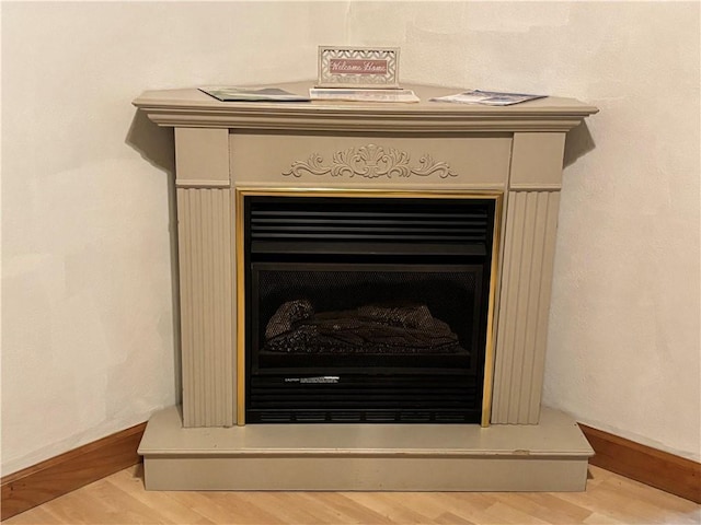 1713 W 8th St, Patterson Twp, PA 15010 - detailed view of a fireplace with raised hearth, wood finished floors, and baseboards
