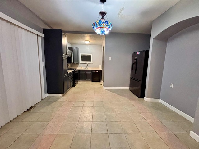 1713 W 8th St, Patterson Twp, PA 15010 - kitchen featuring black appliances, light countertops, light tile patterned flooring, pendant lighting, and arched walkways