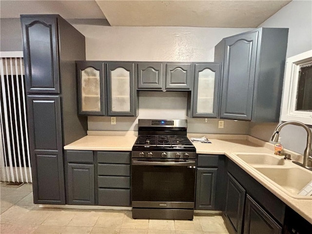 1713 W 8th St, Patterson Twp, PA 15010 - kitchen with gas stove, a sink, glass insert cabinets, and light countertops