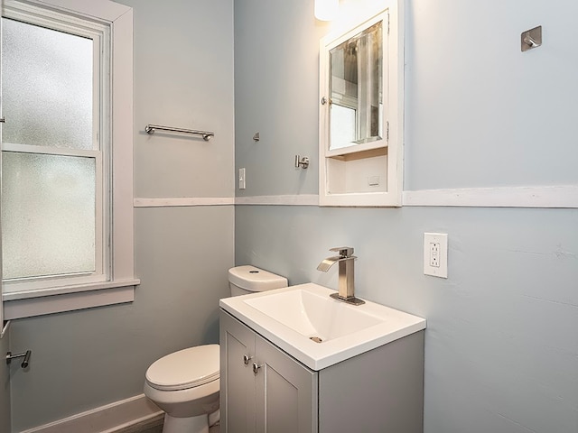 bathroom with vanity, a healthy amount of sunlight, and toilet