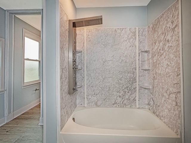 bathroom featuring wood-type flooring and tiled shower / bath combo