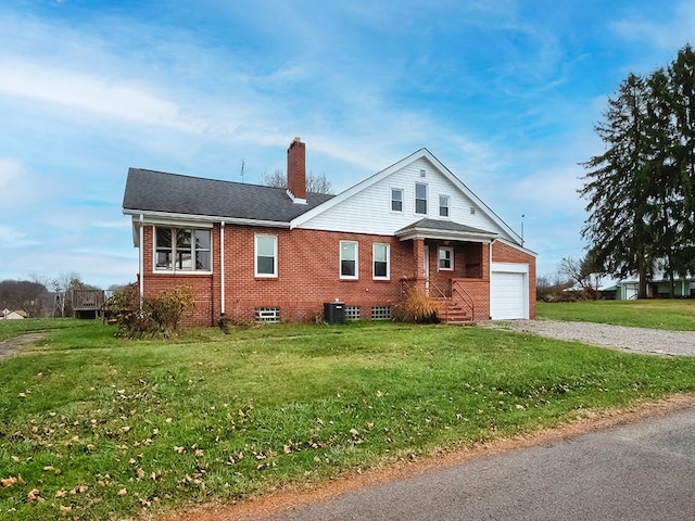 view of front of property with a garage, a front lawn, and cooling unit