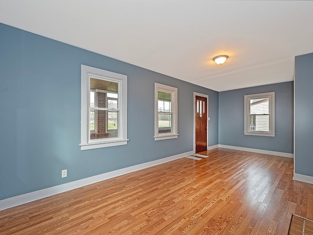 unfurnished room featuring plenty of natural light and light hardwood / wood-style flooring