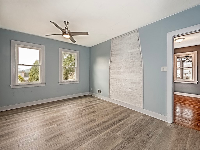 unfurnished room with ceiling fan and light hardwood / wood-style flooring