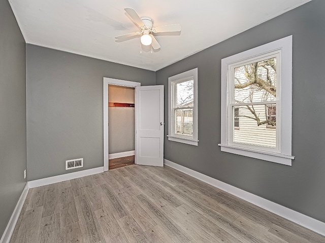 unfurnished bedroom with ceiling fan and light hardwood / wood-style flooring