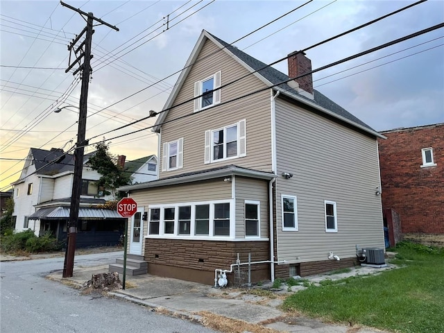 view of side of home featuring cooling unit