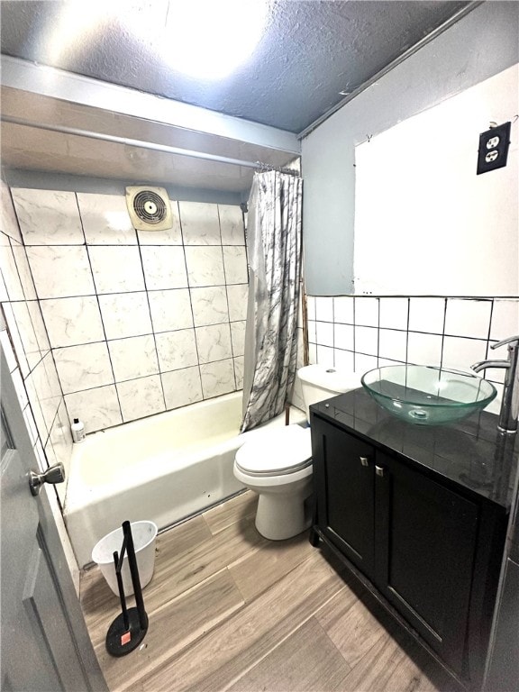 full bathroom with tasteful backsplash, vanity, shower / bath combo with shower curtain, hardwood / wood-style flooring, and toilet