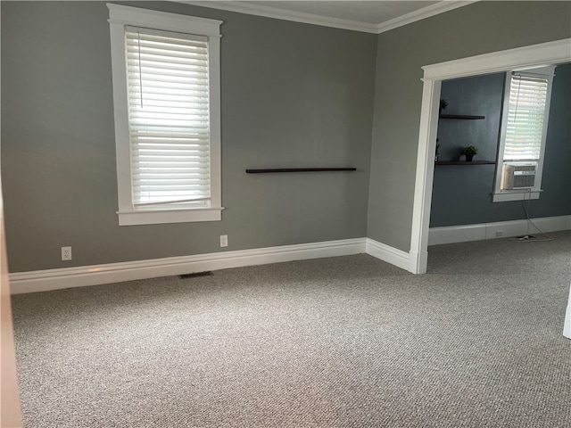 carpeted spare room featuring cooling unit and crown molding