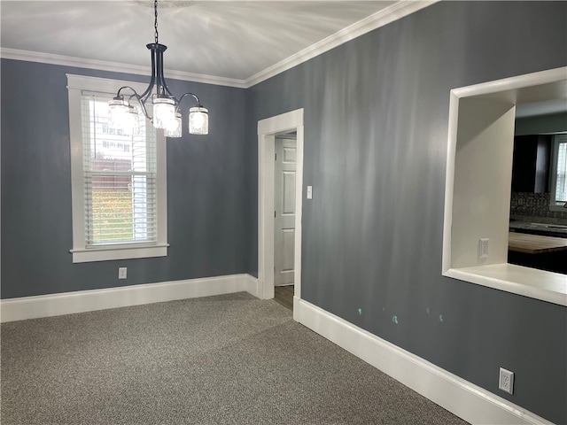 spare room with a notable chandelier, carpet floors, and crown molding