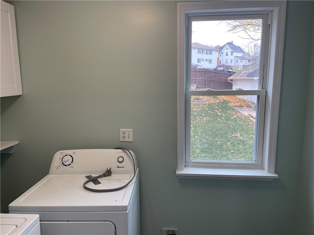 clothes washing area with washer and clothes dryer and plenty of natural light