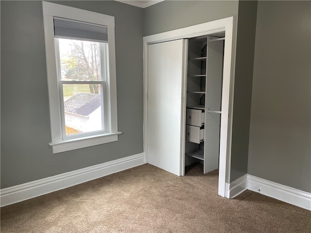 unfurnished bedroom with carpet flooring and a closet