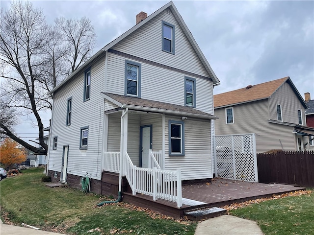 view of front facade with a front yard and a deck