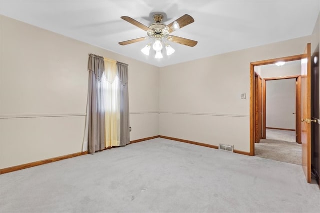 spare room with light colored carpet and ceiling fan