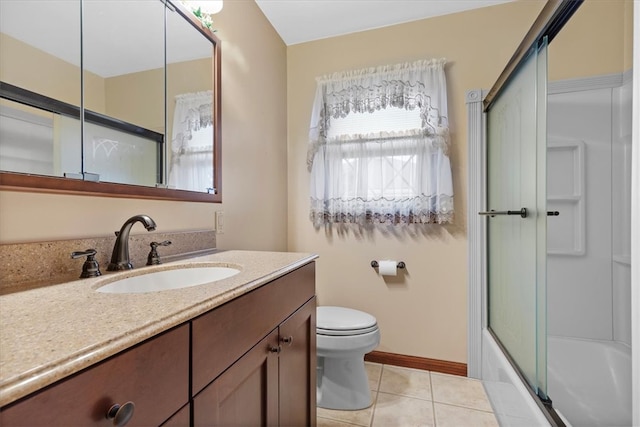 full bathroom featuring tile patterned flooring, vanity, toilet, and shower / bath combination with glass door