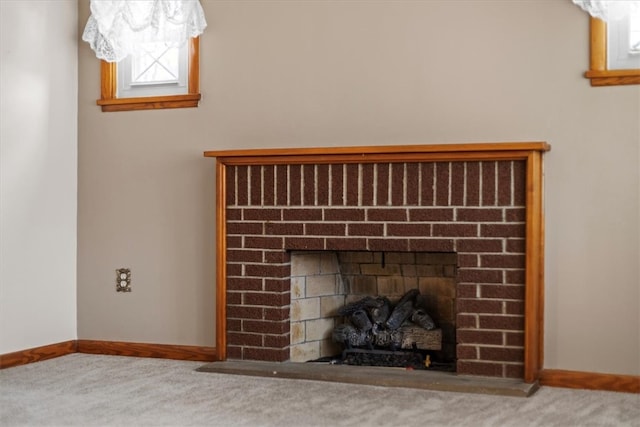 interior details with carpet and a brick fireplace