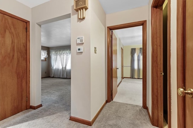 hallway featuring light colored carpet