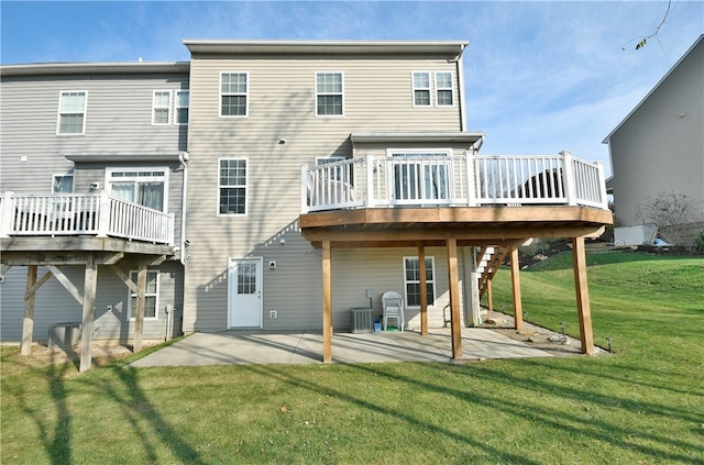 rear view of house with cooling unit, a deck, a patio, and a yard