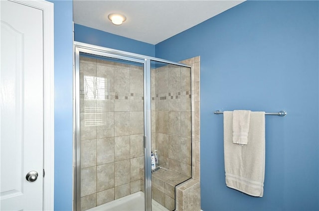 bathroom featuring a shower with door