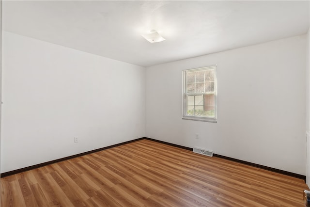 spare room featuring hardwood / wood-style floors