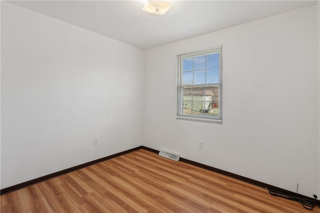 unfurnished room with light hardwood / wood-style floors