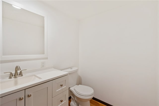 bathroom featuring vanity, toilet, and wood-type flooring