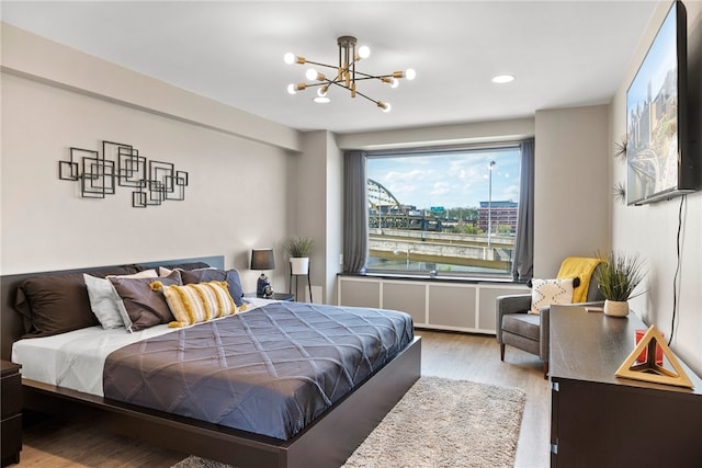 bedroom featuring hardwood / wood-style flooring and a chandelier