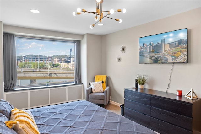 bedroom with a chandelier, hardwood / wood-style flooring, and multiple windows