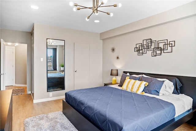 bedroom featuring hardwood / wood-style flooring and a notable chandelier