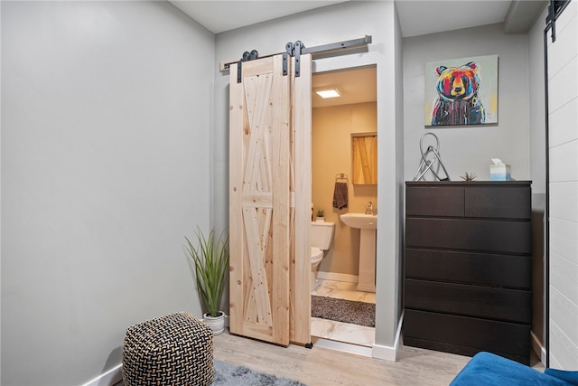 interior space featuring hardwood / wood-style flooring, toilet, and sink