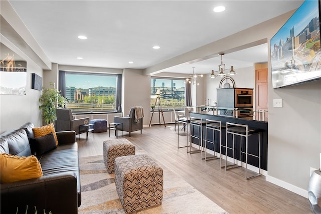 living room with wood-type flooring and an inviting chandelier